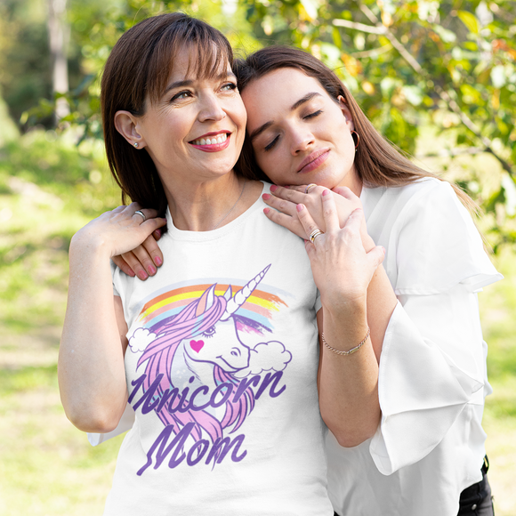 Daughter hugging her mom while she wears a 'Unicorn Mom' t-shirt.